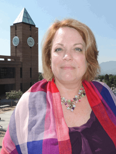 Professional headshot of Vicki Taylor with UCCS Tower in the background